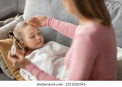 High Fever. Mom Checking Temperature Of Her Sick Daughter Sleeping On Couch At Home, Worried Mother Holding Thermometer And Touching Forehead Of Ill Little Girl Suffering Seasonal Flu, Closeup - Shutterstock ID 2311020343