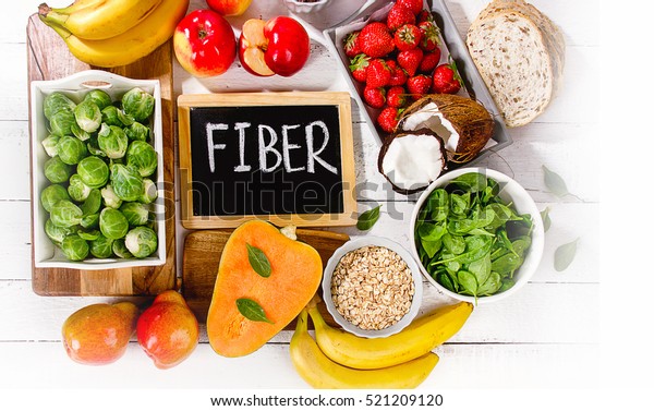High Fiber\
Foods on a wooden background. Flat\
lay