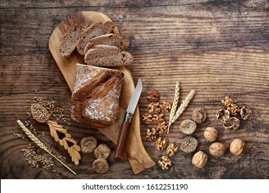 High Fibre Fig And Walnut Rye Bread. High In Vitamins, Antioxidants & Omega 3 With Low Gi. Health Food To Reduce High Blood Pressure, Cholesterol & Optimise A Healthy Heart On Rustic Wood. Flat Lay.