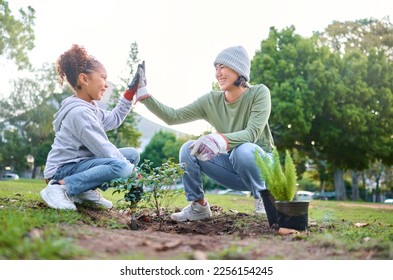 High five, child and woman with plant for gardening, ecology and agriculture in a park with trees. Volunteer family celebrate growth, nature and sustainability for community environment on Earth day - Powered by Shutterstock