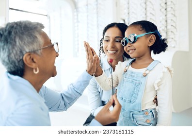 High five, children and a family with a happy optometrist in a clinic for an eye exam to test for prescription frame lenses. Support, motivation or trust with a girl and her parent at the optician - Powered by Shutterstock