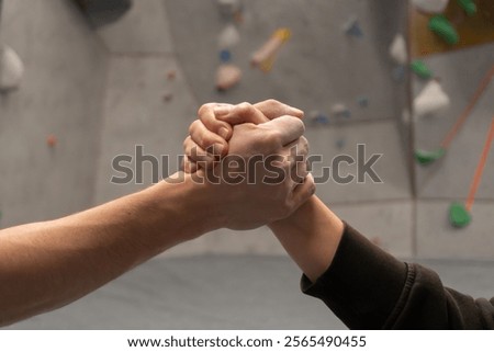 High Five: A Gesture of Teamwork and Collaboration in a Climbing Gym