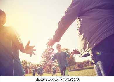 High Five line after a child's soccer game, lens flare, shot into the sunlight, Instagram image