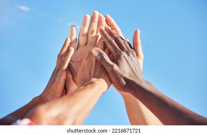 High five, sports and team with support, motivation and solidarity during a game with a blue sky. Group of people, athlete friends or men with hands together for a win, success and partnership - Powered by Shutterstock