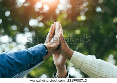 High five teamwork is a team together. unity concept Conservation of nature, the environment, groups of people of various nationalities business team success concept together