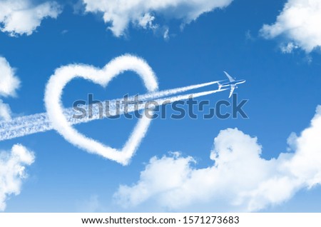 High flying passenger plane pierces the heart in the form of a cloud