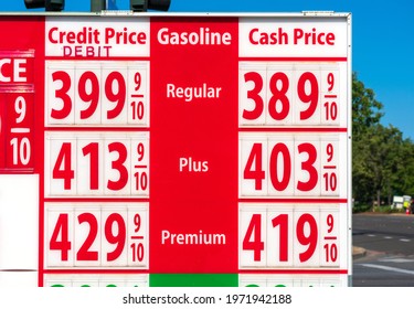 High Gas Prices On Red Sign. Cash, Credit, Debit Price For Regular, Plus And Premium Gasoline.