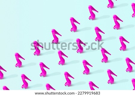 High heel shoes, creative pattern on a pastel blue background. Girl power idea, confidence, strength. 