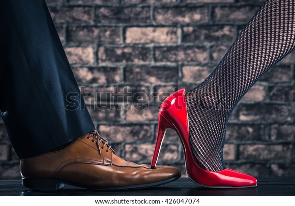High Heeled Women Stepping On Shoes Stock Photo (Edit Now) 426047074