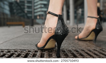 High heels problems. High heel stuck in metal grate on city sidewalk. Woman experiencing shoe problem while walking in heels. Close up of stiletto caught in street drain. Urban fashion accident.