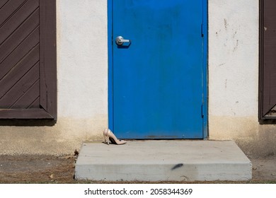 High Heels Sitting Outside Blue Door