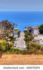 High Hillside View Of A Laguna Beach Street That Leads Down To The Ocean In Summer.