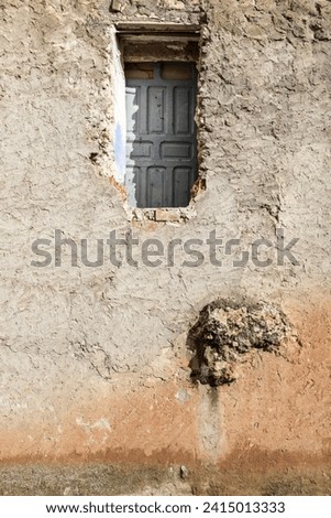High and inaccessible blue wooden door on facade Foto d'archivio © 