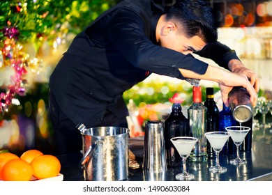 High ISO.Bartender Mixed Drinks, Cocktails At The Outdoor Bar At Night.Night Bokeh