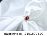 High jewelry banner with color natural gemstone as Patparadcha as Ruby and diamonds on gold ring setting. White satin with tray background for jewelry shop