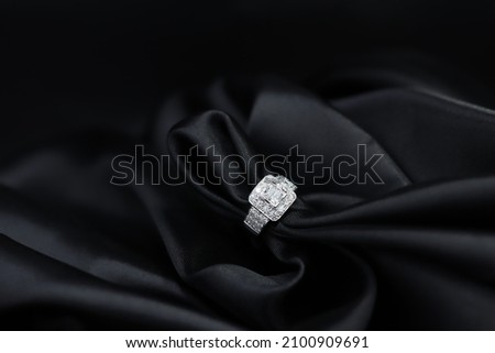 High jewelry banner with diamonds on gold ring setting. Black satin background for jewelry shop