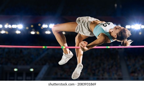High Jump Championship: Professional Female Athlete on World Championship Successfully Jumping over Bar. Shot of Competition on Stadium with Sports Achievement Experience. Determination of Champion. - Shutterstock ID 2083931869