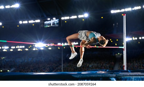 High Jump Championship: Professional Female Athlete on World Championship Successfully Jumping over Bar. Shot of Competition on Stadium with Sports Achievement Experience. Determination of Champion. - Shutterstock ID 2087059264