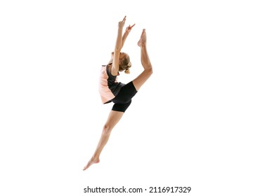 High jump, flight. Little flexible girl, rhythmic gymnastics artist jumping isolated on white background. Grace in motion, action. Doing exercises in flexibility. Beauty, sport, challenges, studying