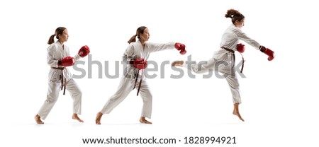 High jump. Junior in kimono practicing taekwondo combat, martial arts. Young female fighter with red gloves training on white studio background in motion, dymanic. Concept of healthy lifestyle, action