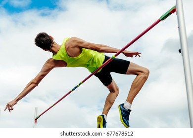 high jump male athlete successful attempt over bar - Shutterstock ID 677678512