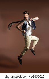 High Jumping Fly Young Handsome Fashion Man On Brown Background