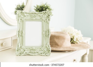High Key Photo Of Vintage Frame On Table With Hat In Front Of The Mirror, Bedroom Scene
