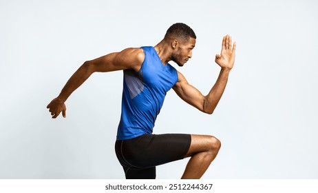 High Knees. Close up of muscular black man doing fitness exercise, lifting leg and waving arm, free space, panorama - Powered by Shutterstock