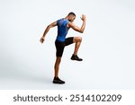 High Knees. Energetic afro man doing fitness exercise, lifting leg and waving arm, free space