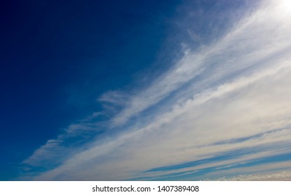 High level cirrus cloud with some stratus  formations  on an autumn morning are contrasted against the blue Australian sky indicating rain within two days.