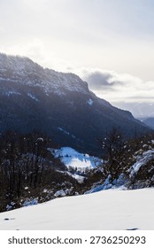 High limestone cliffs of the central Vercors covered in snow in winter, seen from the Coulmes Nordic ski area