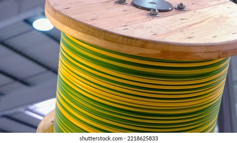 High And Low Voltage Cables In The Storage. Wooden Coil Of Electric Cable Indoor.