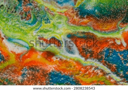 High magnification microscopy recording the complex rheological behavior and transport phenomena at the interface of immiscible non Newtonian fluid layers. The image provides empirical visual data on localized laminar to turbulent transition during the interaction of highly viscous acrylic polymers and low density silicone oil. Distinct boundaries demonstrate convective mass transfer surface tension driven Benard Marangoni instabilities and shear stress deformation patterns within the fluid matrix. This structural formulation serves as factual reference material for computational fluid dynamics CFD simulation validation fluid mechanics modeling and engineering laboratory studies on mixing processes