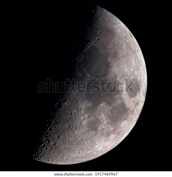 High magnification photo of the moon through\
a telescope. Big moon. Craters and relief of the moon.Moon colored.\
 dark background.