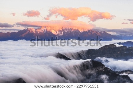 High mountains covered by clouds, sea of clouds, mountain tops, thick clouds