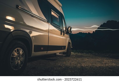 High Mountains Located Campsite Place. Night Time Alpine Wild Camping in a Camper Van. Class B Motorhome. Road Travel Theme.