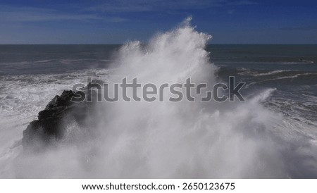 High ocean waves breaking on the rocks of the coastline