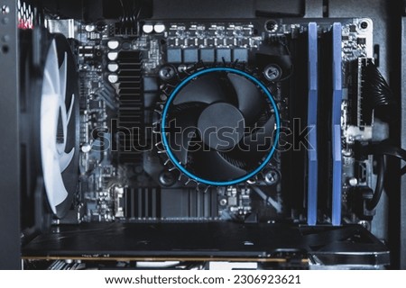  high performance computer. Computer circuit board and CPU cooling fans illuminated by internal LED