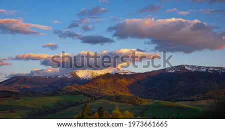 High perspective view of the mountains during sunset. Some mountain peaks. The concept of landscape and nature.