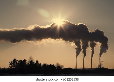 High Pollution From Coal Power Plant. Black Smoke Against Sun. Smoking Chimney Of Industrial Buildings Complex