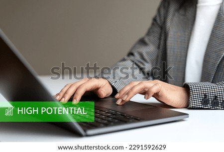 High Potential text and person working on laptop.