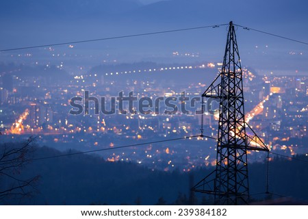 High power electricity poles in urban area. Energy supply, distribution of energy, transmitting energy, energy transmission, high voltage supply concept photo.