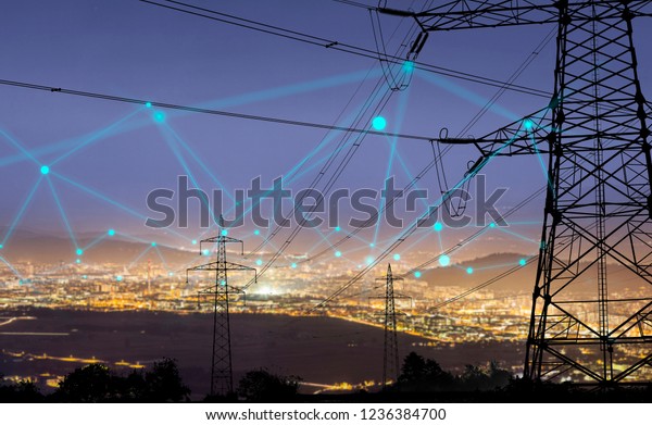 High
power electricity poles in urban area connected to smart grid.
Energy supply, distribution of energy, transmitting energy, energy
transmission, high voltage supply concept photo.
