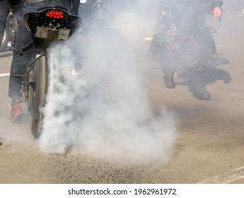 high power motorcycle with racer. Smoke from under the wheels, the racer in the smoke. rear view of an athlete driving a motorcycle. burnt rubber scatters from under the wheels.
