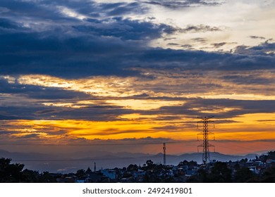 High power pole, silhouette , Sunset, the city. Vivid sunset behind over the small city - Powered by Shutterstock