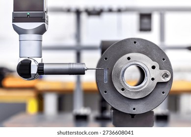 High precision coordinate measuring machine (CMM) inspecting a machined metal part. Ideal for quality control, metrology, precision engineering and industrial manufacturing.
