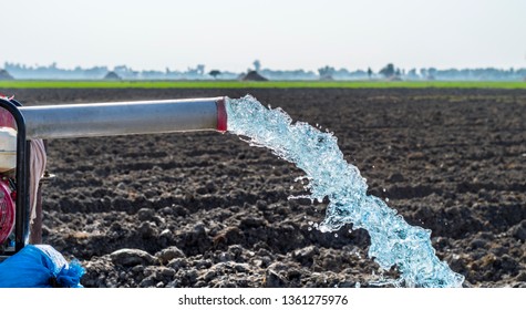 high pressure crystal bluish sweet water flushing out of an agriculture industrial tube well in fields  