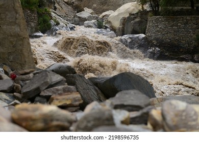 High Pressure Flood Water In Mountain River Tributary, Caused By Global Warming, Melting Glaciers And Torrential Rains. With Selective Focus And Depth Of Field.