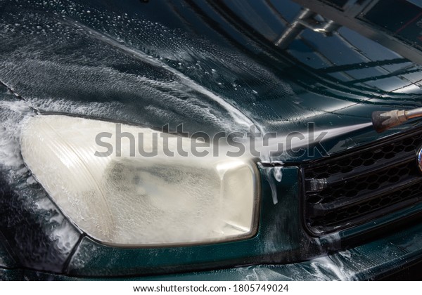 High pressure washing car\
outdoors