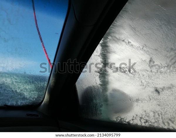 High pressure water car cleaning service - view from the\
inside car. 